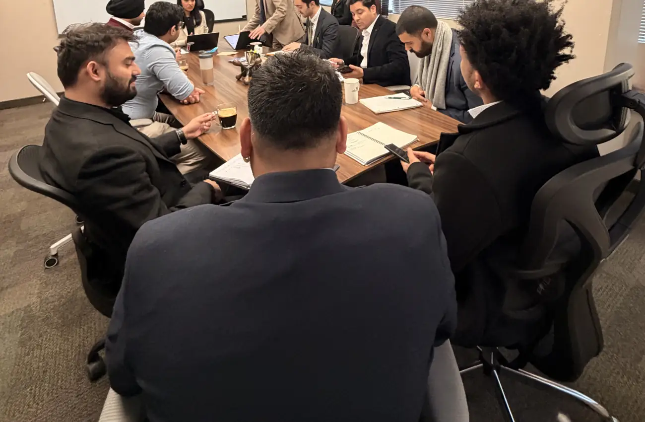 DucMeta team members in a training session around the boardroom table